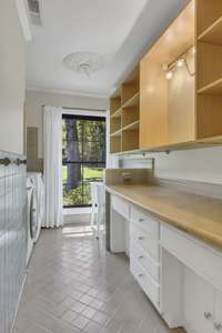 Hall laundry room with great storage.