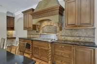 Gas cooktop with warm tile backsplash.