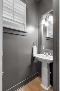 The downstairs half bath provides a fun pop of moodiness.