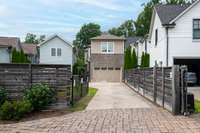 Gated driveway with rear-entry garage access.