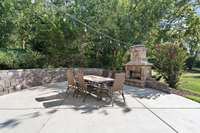 Outdoor patio with stone fireplace