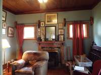 Parlor/office with tongue and groove ceilings, wide baseboards and mantle/gas logs