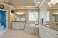 The primary bathroom is so spacious.  Ceramic Tile floors, Granite counters and storage galore!