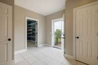 Ceramic Tile floors leading to side door and laundry room.