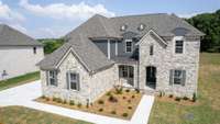 Gorgeous Stacked stone accents and attractive brick enhance the exterior beauty of this NEW home! Covered Porch and 8 Foot wood double Entry doors invite you into this custom designed home with high end finishes and located on a cul-de-sac