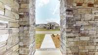 Architecturally pleasing stone accents and a front porch create a welcoming facade and draw you into this gorgeous home while providing protection from the elements