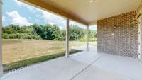 Large covered Porch overlooks the spacious lawn and open space with the lush green surrounding hills of Middle Tennessee as your view