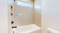 This lovely bath has a tile surround on the tub/shower combo