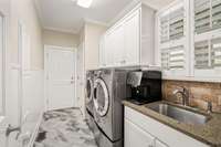 Laundry room leading to two car garage