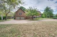 The large two-car garage is on the side of the house and there is plenty of extra parking.