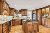 The kitchen features high quality cabinets, granite countertops, tile backsplash and newer appliances.