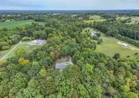 Looking at this photo the adjoining 17+ acres to the right can be purchased. When entering the driveway from the street the additional acreage will be on your left.