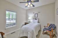 Bedroom #4 offers a view of the expansive rocking chair front porch and includes a ceiling fan and a walk-in closet. It also connects to a full bath