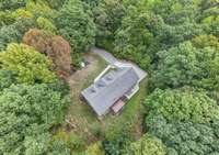 Nestled in the trees, this home offers a serene and private setting.