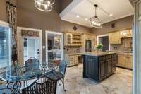 The kitchen with breakfast nook opens to the back patio for morning coffee. It has stainless appliances, new light fixtures, and fresh paint throughout.