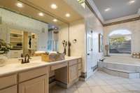 Large Primary en-suite bath with double vanities, separate tub and shower, linen closet and walk-in closet.