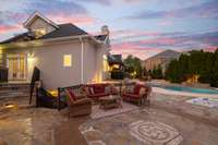 Veranda from the Primary Suite opens to a beautiful sitting area near the hot tub with lake views.