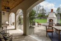 outdoor covered patio and gorgeous arched walkways, outdoor fireplace