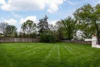 flat, gorgeously manicured lawn in back