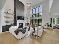 Grand Family Room with gas fireplace and marble and granite fireplace hearth, white oak shelving stained to match floors