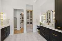 Lighted makeup mirror, gorgeous sconces, plentiful cabinetry and linen cabinet to keep everything tucked away