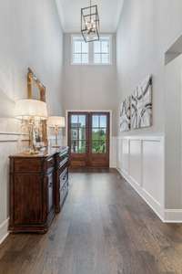 This spacious 2-story Foyer with soaring ceilings leaves a lasting first impression with extensive wide plank hardwood flooring (throughout most of the main living areas of the home).