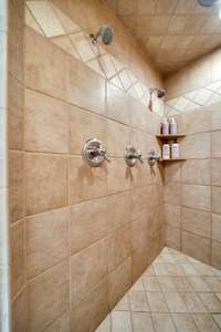 Dual shower heads in the large tiled shower