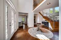 Entry foyer welcomes guests to your home! Note the transom windows above the doorways...numerous custom build features like this throughout the home.