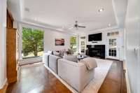 Den leads to the covered screened porch and kitchen/breakfast area