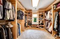 Built ins in the Primary Bedroom Closet provide ample storage and organization