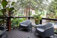 The back porch overlooks the back yard (created and maintained by a Master Gardener!) and has a stylish shade cover that can be installed and removed as needed.