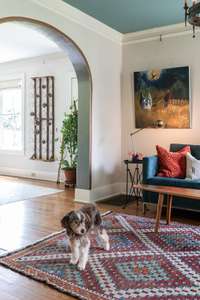 The archways and original picture rails in this home are some of the many original and period-appropriate details you'll uncover throughout.