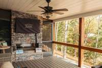 The upper level features both a screened porch and open, covered porch with staked stone double sided gas fireplace. Home has a Seller owned 1000gal buried propane tank.