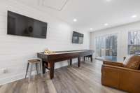 Wet bar/Lounge area with sliding doors onto upper level deck. Perfect place to unwind and watch the game!