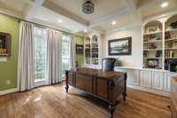 Just off the entry is a private office with french doors, built in bookshelves/cabinets, coffered ceilings and recessed lighting.