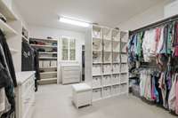 The primary closet has abundant room for all seasons of your wardrobe, plus a window for natural light.