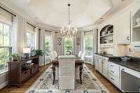 The breakfast nook couldn’t be more beautiful with the vaulted ceiling detail, bay window and  custom built in buffet.