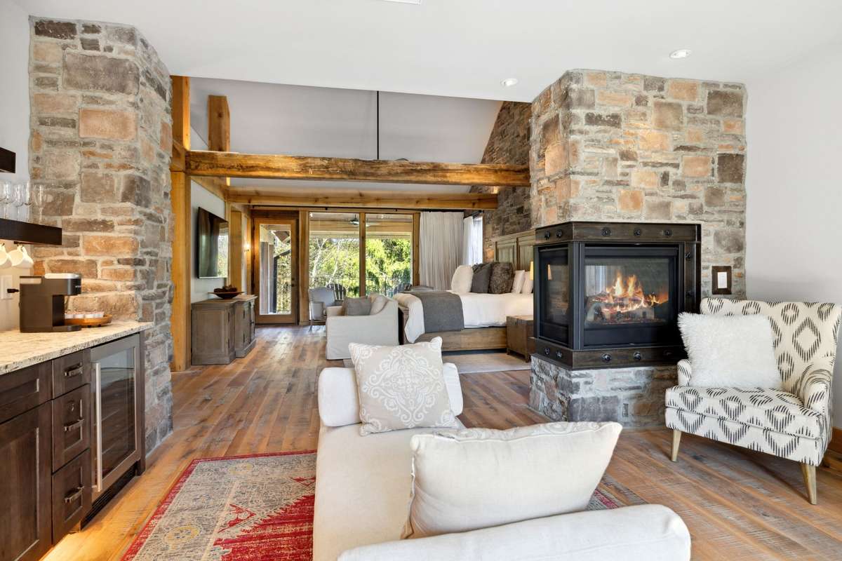 Primary suite - on second level, with coffee bar, fireplace, and oversized private balcony.