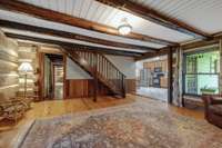 Second staircase leading to an upstairs bedroom is uniquely crafted of gleaming hardwoods