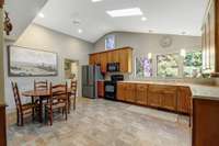 Kitchen is a bright space with high ceilings and skylights