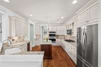 Kitchen complete with custom cabinetry and updated granite