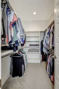 The primary suite's massive walk-in closet is completed with custom shelving and organization.