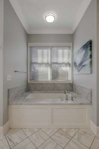 The en-suite bath to the primary suite is the most refreshing space to unwind after a long day!