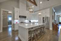 Walk-in pantry with hidden door to the left of the fridge.