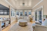 Cozy den with French doors open to inviting screened porch