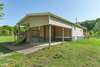 Attached carport with concrete parking