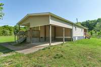 Attached carport with concrete parking