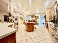 This custom kitchen offers ample custom cabinet space/storage with desk area and lots of counter space