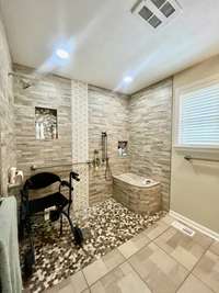 Can't get enough of this One Of A Kind Wheelchair Accessible Roll In Shower in the Primary Suite! No Shower door needed!