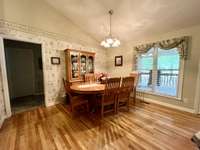 Large Dining Area overlooking the large covered deck. Vaulted ceilings; hardwood flooring